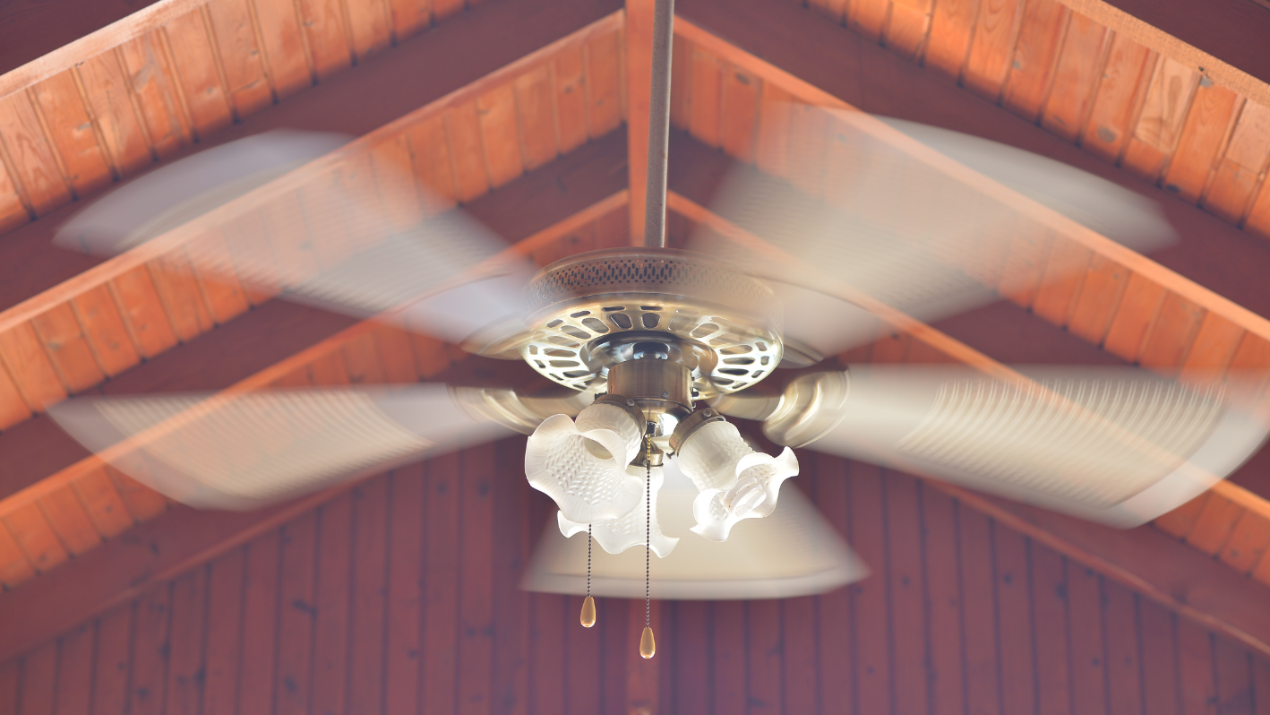 A ceiling fan in a wooden room with a ceiling fan