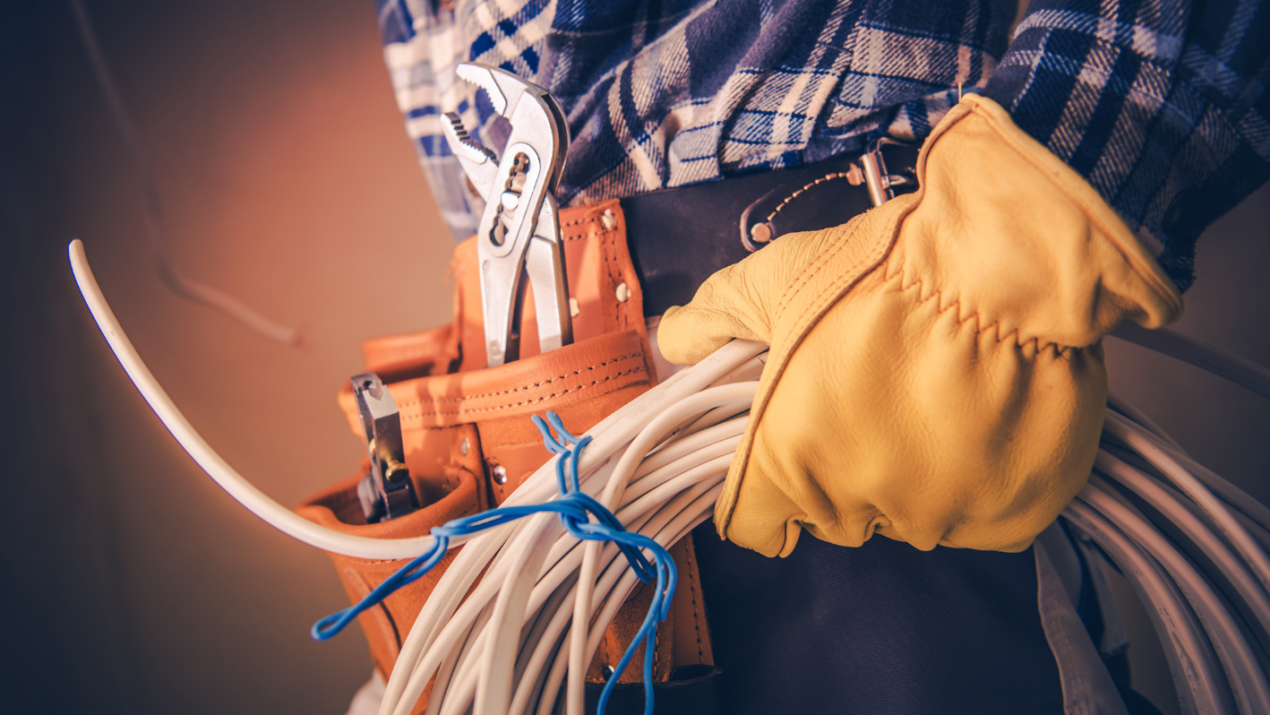 A person holding a bunch of tools in their hands