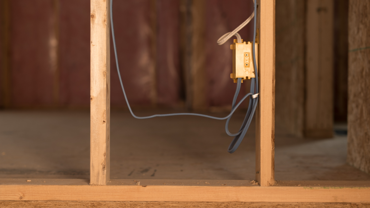 An electrical outlet is connected to a wall